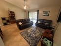 Inviting living room with tile flooring, plush sofas, and sliding glass doors to the exterior at 4012 King Edward Dr, Orlando, FL 32826