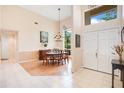Elegant dining room with high ceilings, tile and wood floors, chandelier, and abundant natural light at 4119 Pecan Ln, Orlando, FL 32812