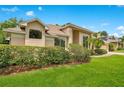 Beautiful home showcasing lush landscaping, mature trees, and manicured lawn on a sunny day at 4119 Pecan Ln, Orlando, FL 32812