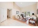 Inviting living room with neutral walls, tile and wood floors, with double doors to the outside at 4119 Pecan Ln, Orlando, FL 32812