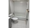 An all-white bathroom featuring a shower-tub combo with white tile, a toilet, and a vanity at 4617 Frisco Cir, Orlando, FL 32808