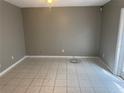 This living room has tile flooring, gray walls, and a ceiling fan at 4617 Frisco Cir, Orlando, FL 32808
