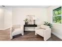 Cozy sitting area with modern decor, plush chairs, stylish table, and an abundance of natural light at 577 Compton Ct, Deland, FL 32724