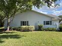 Side view of home with neat landscaping, manicured lawn and a serene atmosphere at 6042 Wade St, Leesburg, FL 34748