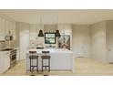Bright modern kitchen featuring an island with seating, stainless steel appliances, and white cabinetry at 6168 Sw 154Th St, Ocala, FL 34473