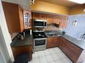 Functional kitchen features stainless steel appliances and wooden cabinetry at 68 S Marbrisa Way, Kissimmee, FL 34743