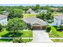 Charming single story home boasts a well-manicured lawn and three car garage at 721 Lake Cove Pointe Cir, Winter Garden, FL 34787