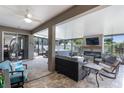 This covered patio features a fireplace, outdoor seating, a ceiling fan, and a hot tub at 721 Lake Cove Pointe Cir, Winter Garden, FL 34787