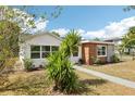 A well maintained lawn with a small tree in the front yard, compliments a modern single story home at 730 W Swoope Ave, Winter Park, FL 32789