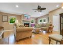 Cozy living room featuring a stone fireplace, hardwood floors, and plenty of natural light at 8316 Granada Blvd, Orlando, FL 32836