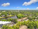 Expansive aerial view with a lake, trees, and condo community in the distance at 960 Mooring Ave # 202, Altamonte Springs, FL 32714