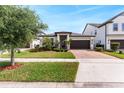 Beautiful one-story home with brick-paved driveway, complemented by mature trees and lush lawn at 10072 Hampshire Oaks Dr, Orlando, FL 32825