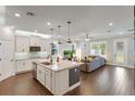 Open kitchen featuring stainless steel appliances, granite countertops, and a central island at 10072 Hampshire Oaks Dr, Orlando, FL 32825