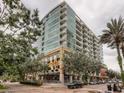 Contemporary condo building featuring balconies, ground-floor restaurant, and well-maintained landscaping, creating an inviting urban ambiance at 101 S Eola Dr # 720, Orlando, FL 32801