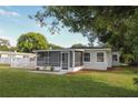 Charming home exterior featuring a screened porch and mature trees at 1016 E Fillmore Ave, Orlando, FL 32809