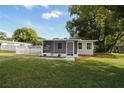 Home exterior features a screened porch and fresh landscaping at 1016 E Fillmore Ave, Orlando, FL 32809