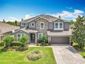 Beautiful two-story home showcasing well-maintained landscaping and a paved driveway leading to the garage at 1078 Vinsetta Cir, Winter Garden, FL 34787
