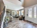 Inviting living room with high ceilings, elegant decor, and an ornate front door with leaded glass at 1078 Vinsetta Cir, Winter Garden, FL 34787
