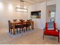 Bright dining room with decorative wainscoting, stylish lighting, and tile flooring at 110 S Primrose Dr, Orlando, FL 32803