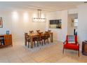 Bright dining room with decorative wainscoting, stylish lighting, and tile flooring at 110 S Primrose Dr, Orlando, FL 32803