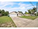 Traditional single-story home featuring a spacious driveway, neutral tones, and an attached two-car garage at 1139 Humphrey Blvd, Deltona, FL 32738
