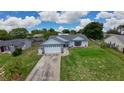 An elevated view showing a well-manicured lawn, a driveway, and mature trees surrounding the property at 119 Ridgecrest Dr, Eustis, FL 32726