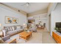 Bright and airy living room with neutral tones, dining space, and views of the kitchen at 12107 Poppy Field Ln # 105, Orlando, FL 32837
