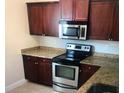 Contemporary kitchen with stainless steel microwave and granite counters at 1325 Rotonda Pt # 117, Lake Mary, FL 32746