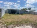A backyard featuring a covered patio area with an adjacent shed, and secure fencing at 1414 Park Manor Dr, Orlando, FL 32825