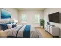 Bright bedroom with light wood flooring, calming color accents, and streaming natural light from the windows at 14957 Sw 63Rd Court Rd, Ocala, FL 34473