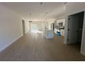 Open-concept living room and kitchen with island, stainless appliances, and sliding glass doors at 14957 Sw 63Rd Court Rd, Ocala, FL 34473