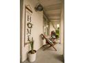 Relaxing front porch with stylish seating, potted plants, and a 'Welcome to Our Home' sign at 1529 Glastonberry Rd, Maitland, FL 32751