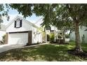 Charming two-story home with a well-maintained lawn and a walkway leading to the front door at 1645 Boulder Creek Ct, Apopka, FL 32712