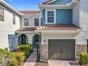 Beautiful two-story townhome with a tile roof and a well-maintained brick driveway at 1772 Garden Sage Dr, Oviedo, FL 32765