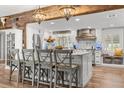 Spacious kitchen with a large island, pendant lighting, stainless steel appliances, and custom wood accents at 2105 Fosgate Dr, Winter Park, FL 32789