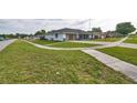 Suburban home with a spacious yard and a well-manicured lawn, situated in a friendly neighborhood setting at 211 Marion Oaks Ln, Ocala, FL 34473