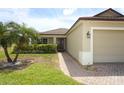 Lovely home featuring a tropical palm tree, stone walkway and covered entryway with nice landscaping at 212 Regency St, Davenport, FL 33896