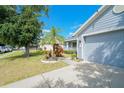 Exterior showcasing the home's siding, garage, landscaping and front yard in a residential neighborhood at 2709 Prestwick Ln, Kissimmee, FL 34744