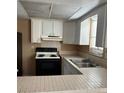Functional kitchen with white cabinetry, tile countertops, and essential appliances at 3040 Pinder Ct, Orlando, FL 32811