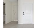 Inviting entryway with a white front door, neutral walls, and tile flooring, leading to other rooms in the home at 3222 Sweet Acres Pl, St Cloud, FL 34772