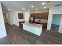 Modern kitchen features granite countertops, a central island, stainless steel appliances, and wood cabinets at 3408 Curlew Ave, Leesburg, FL 34748
