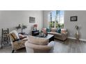 Living room with an arched window, comfortable seating, and stylish decor at 4027 Lakeside Reserve Ct, Orlando, FL 32810
