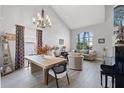 Open-plan living room features vaulted ceilings, a dining area, and a large arched window at 4027 Lakeside Reserve Ct, Orlando, FL 32810