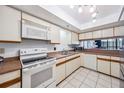 Traditional kitchen with white appliances, wood-trimmed cabinets, and a charming pass-through window at 530 E Central Blvd # 1702, Orlando, FL 32801