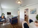 Spacious living room with wood floors, modern decor, and an open floor plan at 5481 Nokomis Cir, Orlando, FL 32839