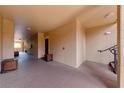 Well-lit hallway features smooth flooring and beige walls, leading to multiple units and stairwell access at 5500 Metrowest Blvd # 203, Orlando, FL 32811