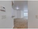 Bright living room showcasing neutral carpet and walls, with a large window offering natural light and views at 5500 Metrowest Blvd # 203, Orlando, FL 32811