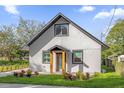 Charming home featuring a neutral paint, framed windows, and lush landscaping at 600 Lakewood Ave, Ocoee, FL 34761