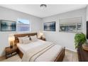 Relaxing main bedroom with two windows, neutral walls, and bedside tables at 619 Carver Dr, Lake Wales, FL 33853