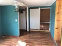 Bedroom with blue walls, wood floors, ceiling fan, closet, and window at 636 S Wellington Dr, Deltona, FL 32725
